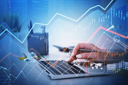 Businesswoman hands or stock trader analyzing stock graph chart by using laptop to buy or sell...