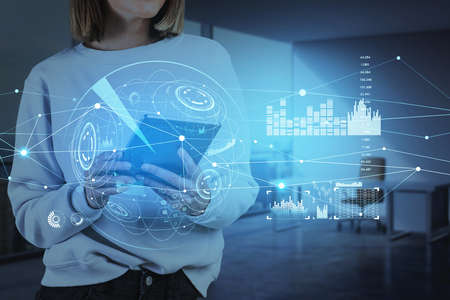Tablet device in hands, businesswoman browse the Internet. HUDs with digital interface, information...