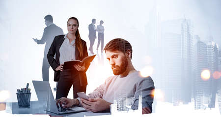 Confident business woman standing with open notebook, hand on waist. Silhouettes of working business...