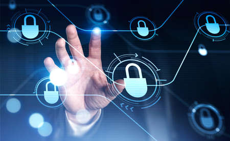 Close up businessman hand touching blue glowing information protection padlock icons. Concept of...