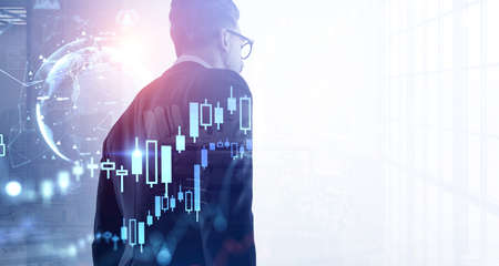 Businessman at office open space, candlesticks forex hologram changes with quotations and glowing...