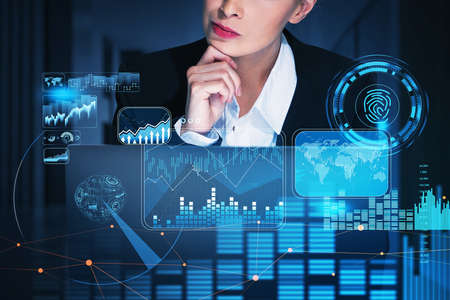 Businesswoman working in front of laptop, blue hologram glowing digital information security...