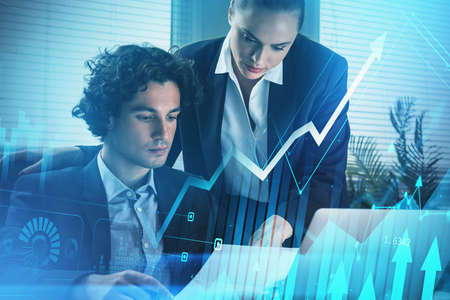 Businessman and businesswoman or stock traders analyzing stock data to apply new strategy to beat...