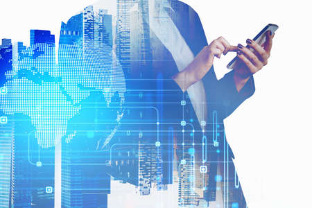 Businesswoman is looking for investments business opportunities by smartphone. Double exposure of...