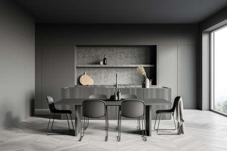 Dark cozy kitchen room interior with dining table, six chairs, parquet floor, electric cooker and...