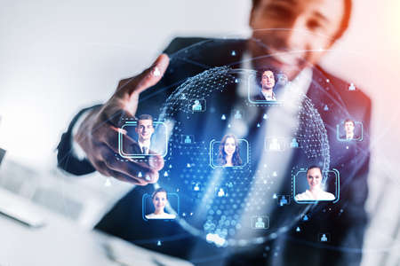 African American businessman holding out the hand for handshake as a concept of recruitment process for the international project. Social media people icons and hologram of worldwide globeの写真素材