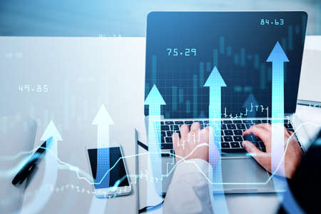 Businessman or stock trader analyzing stock graph chart using laptop to buy or sell stock, forex bar...