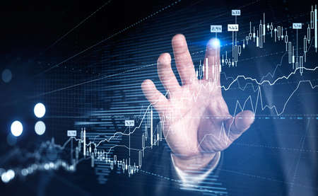 Businessman in formal suit is touching forex graph with his finger. Financial chart with...