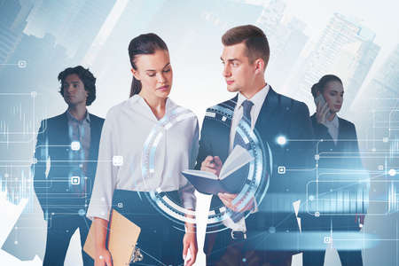 Group of business people work together discussing new working strategy. City skyscrapers in the background. Digital interface with chart and bar diagram in the foreground. Concept of teamworkの写真素材