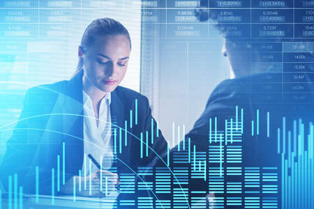 Businesswoman and businessman wearing formal suit work together. Financial chart and graph in the...