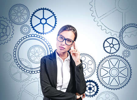 Thoughtful businesswoman wearing formal suit is thinking about new creative ideas for company. Wall...