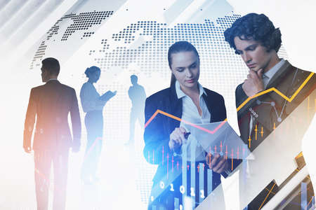 Group of business people work together discussing new working strategy. Virtual globe in background. Financial graph and candlesticks in foreground. Concept of teamwork, cooperation and communicationの写真素材