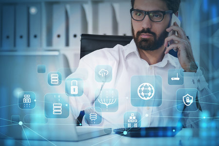 Businessman wearing white shirt is working on laptop and smartphone with hologram of globe, padlock,...