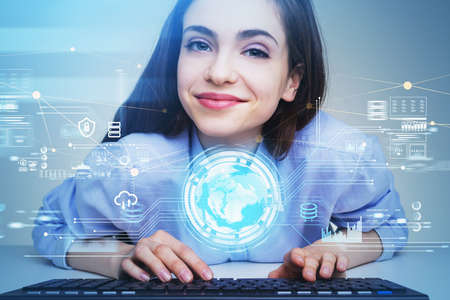 Businesswoman wearing blue shirt is typing message on keyboard. Office workplace in the background....