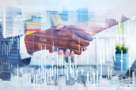 African American trader wearing formal suit shakes hands with businesswoman. Office workplace and...