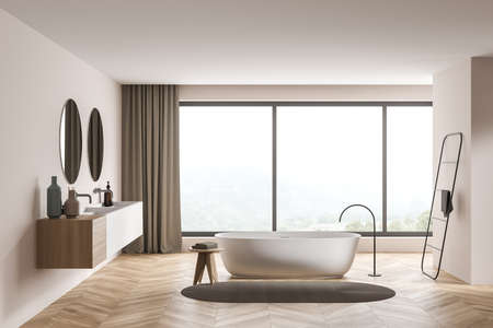 Modern beige bathroom interior with a panoramic view, trendy details, an oval white ceramic bath, a...