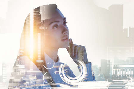 Businesswoman wearing white shirt is holding her chin. Digital interface with circle hologram in the foreground. Singapore city skyscraper financial downtown in the background. Concept of leadershipの写真素材