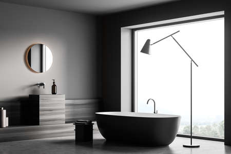 Corner view on dark bathroom interior with bathtub, panoramic window, white wall, round mirror, towels and concrete floor. Concept of minimalist design for relaxation. 3d renderingの写真素材