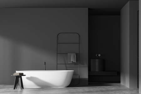 Dark bathroom interior with empty gray wall, bathtub, towel, sink and concrete floor. Concept of hygienic and spa procedures for health. 3d renderingの写真素材