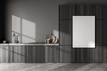 Close view on dark kitchen room interior with white empty poster, gray wall, cupboard and concrete...