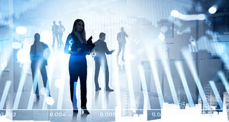Attractive businesswoman in black dress is holding clipboard. Group of business people work together...