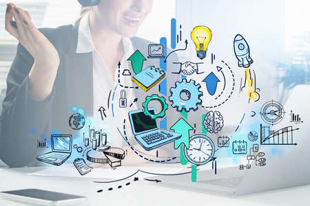 Businesswoman wearing formal suit is working on laptop. Office workplace with colorful sketch with...
