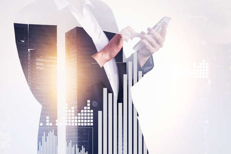 Businesswoman wearing formal suit is typing message on smartphone. Digital interface with bar...