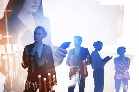 Group of business people wearing formal suits work together using smartphone, notebook and...