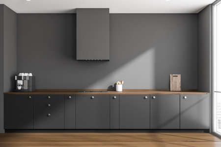 Modern gray kitchen interior with easy cabinets, heat extractor and wooden worktop with flooring. Concept of on trend design. 3d renderingの写真素材