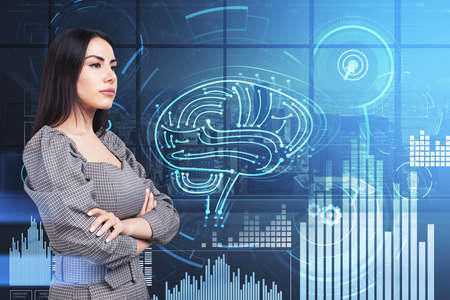 Young attractive businesswoman wearing grey dress is standing in cross arm pose. Digital interface...