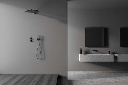 Minimalist dark grey shower room interior with concrete floor, shelf vanities, square mirrors and...