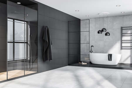 Corner of grey and black bathroom interior with oval bathtub, pendant lamps, steel details, framed glass partitions and shower cabin. Tiles. Modern apartment design concept. 3d renderingの写真素材