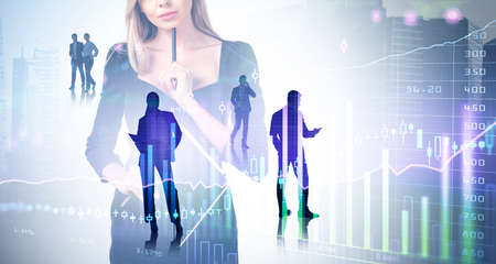 Businesswoman wearing formal suit is holding clipboard. Group of business people work together...
