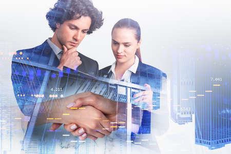Businessman and businesswoman shake hands, double exposure of two people and digital icons, bar...