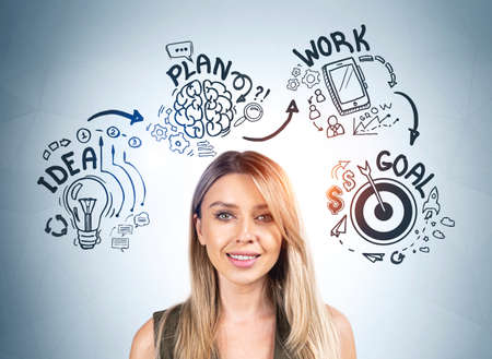 Smiling attractive businesswoman is standing near sketch with light bulb, rocket launch start up,...