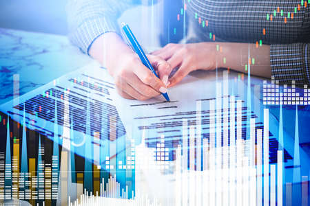 Businesswoman signing a contract, office workplace. Double exposure of growing stock market bar...