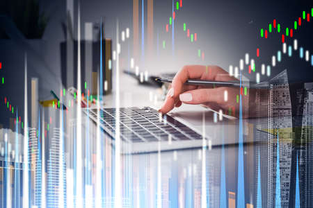 Close up businesswoman hand with pen is typing laptop keyboard to continue trading operations....
