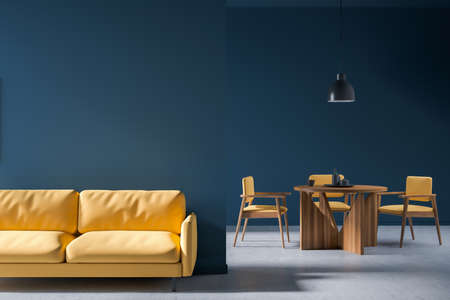 Dining interior with yellow couch and wooden table with dishes. Bright guest waiting room with...