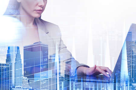 Office woman fingers typing on computer keyboard, stock market bar dynamics with lines and chart with numbers, double exposure. Concept of trader and financial advisorの写真素材