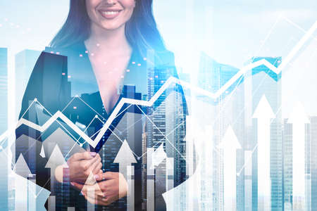 Office woman smiling with device in hands. Double exposure with glowing rising arrows and lines, cite view. Concept of global market and successの写真素材