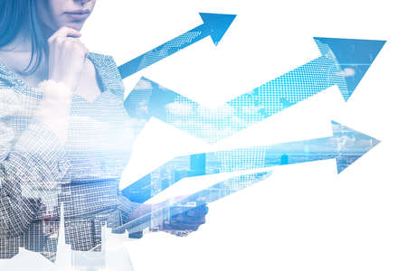 Office woman think, using device in hand, pensive look. Double exposure with growing arrows, lines and doodle earth globe hologram. Concept of global market and growthの写真素材