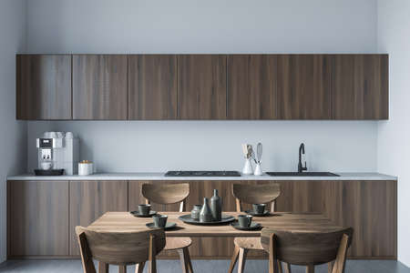 Minimalist cooking interior with four wooden chairs and dining table with dishes. Sink and stove,...