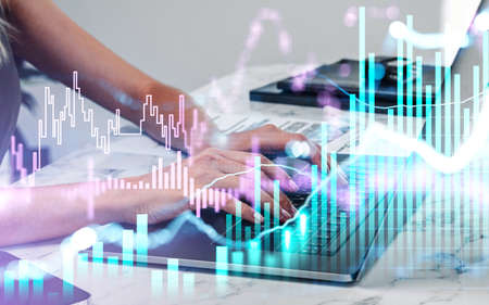 Close up businesswoman hand is typing laptop keyboard to continue trading operations. Concept of...