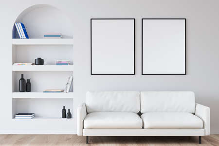 Two empty canvases on wall over two seater sofa near arched niche shelf in white living room with wood flooring. Modern interior design concept. Mock up. 3d renderingの写真素材
