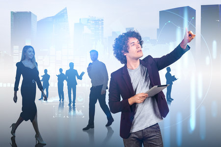 Businessman with tablet finger point at growing lines, silhouettes of people working together, double exposure of city skyscrapers. Concept of financial analysis and networkの写真素材
