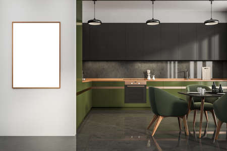 Minimalist dining room interior with green armchairs, dishes on table and kitchen set, tiled floor. Copy space frame on black wall, 3D renderingの写真素材