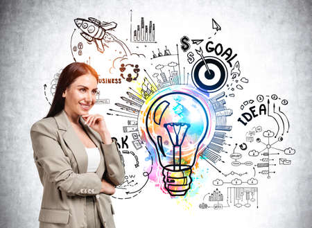 Businesswoman wearing formal coat is touching chin with hand. Colorful sketch with bar and pie diagram, light bulb, rocket launch, start up, goal on wall in the background. Concept of imaginationの写真素材
