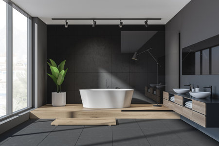 Black bathroom interior, two sinks with mirror, tub on wooden podium. Modern bathing room with tiled floor and window on countryside, 3D renderingの写真素材