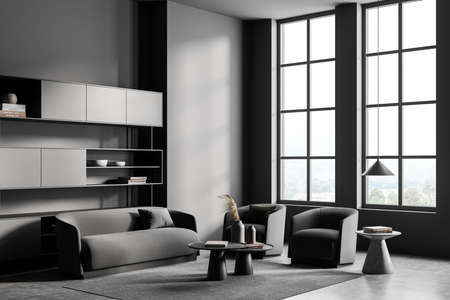 Dark guest room interior with two gray armchairs and couch on carpet, gray concrete floor, coffee...