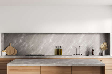 White cooking interior with sink, deck with kitchenware, front view. Luxury kitchen with decoration and appliances, 3D renderingの写真素材